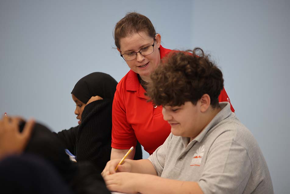 students and teacher working in classroom