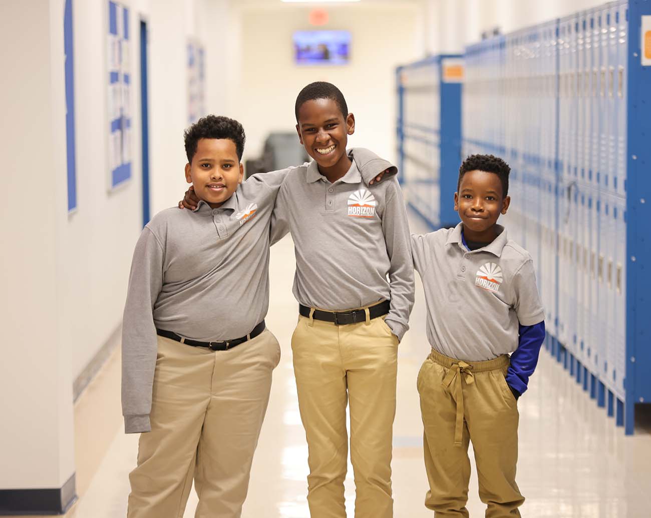 Teacher or school staff member warmly interacting with a student outside